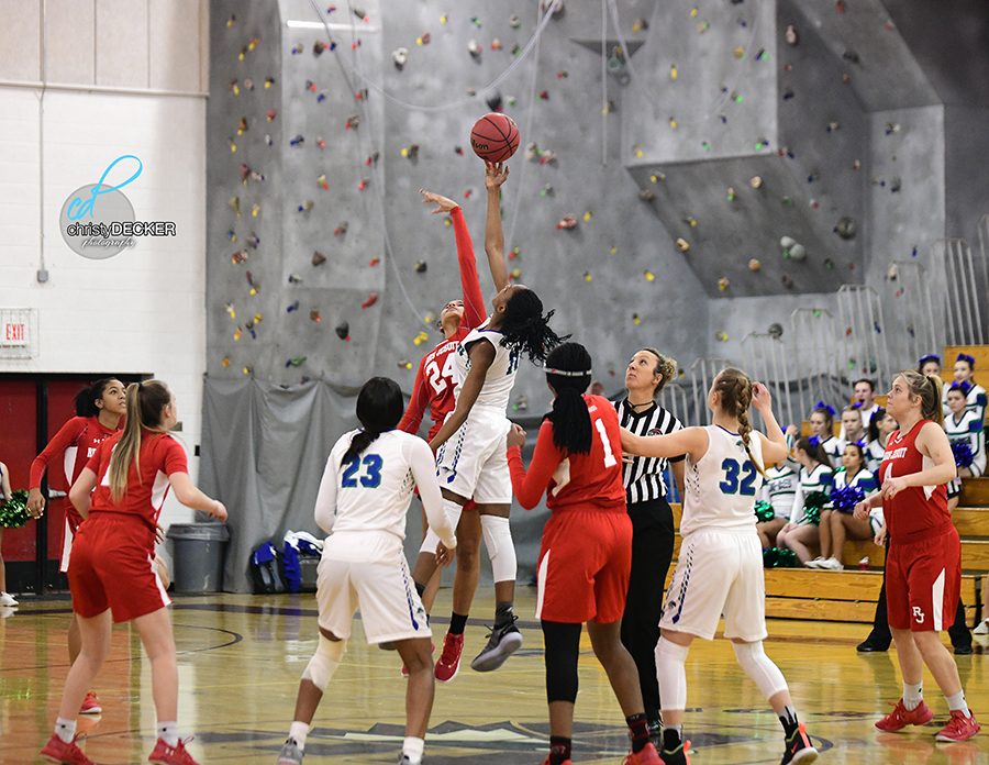 Aujunae Latimer grabs the tip in the opening of the game against Regis Jesuit.
