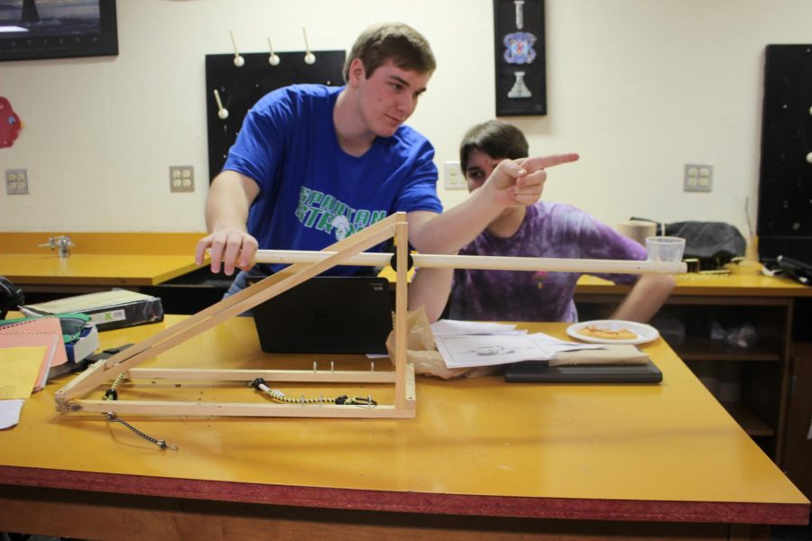 Jack Bopp and his partner modifying their project catapult.