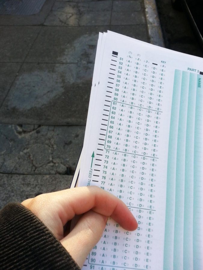 A student holds a standard scantron.