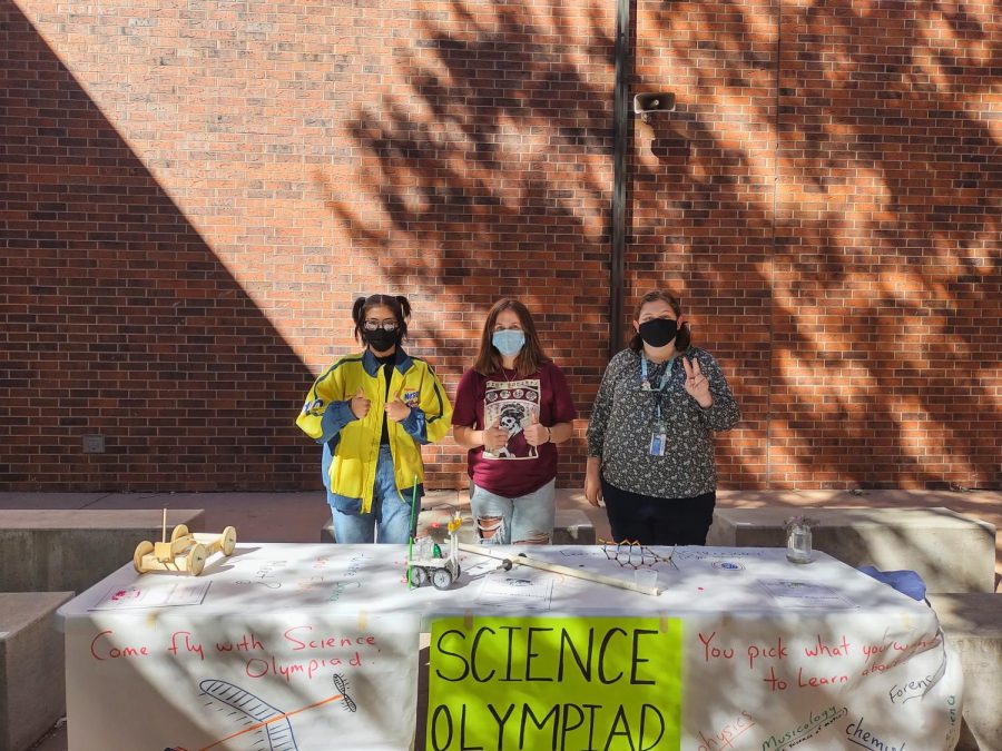 Science Olympiad students Emily Taylor Sadie Duffy stand with club advisor, Amy Robinette, at the Doherty High School Club Fair.