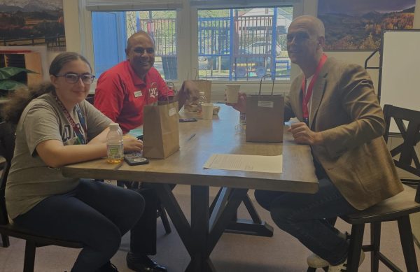 Annika Norman with Superintendent Michael Gaal and school board president Parth Melpakam at Queen Palmer Elementary School 