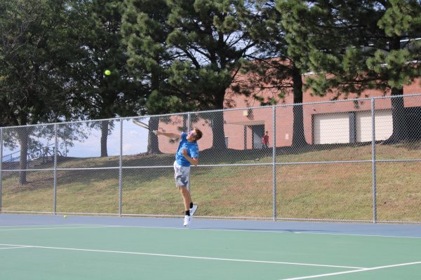 Riley sack warms up his serve