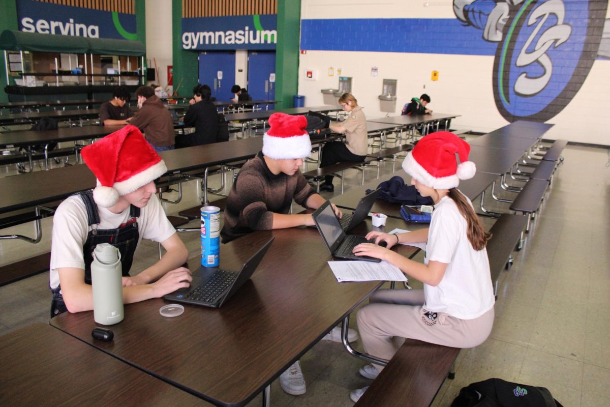 Students+studying+hard+in+the+cafeteria+and+showing+some+school+spirit+with+there+santa+hats