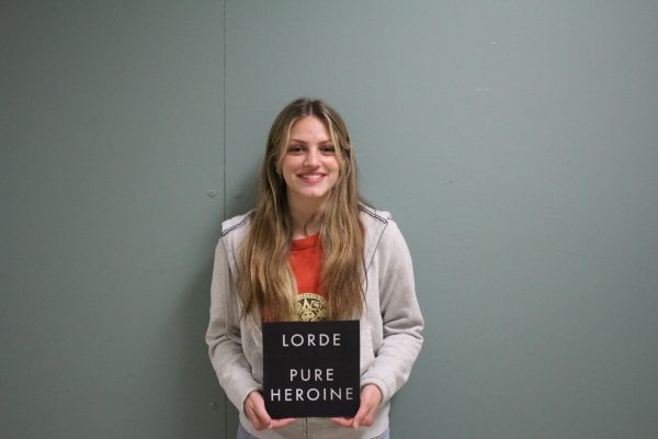 Junior RyeLynn Conklin poses with Album Pure Heroin by Lorde that includes song Team