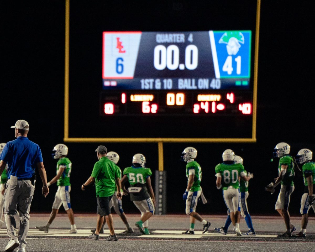 Doherty's football team walking in mid-field after Liberty game. 