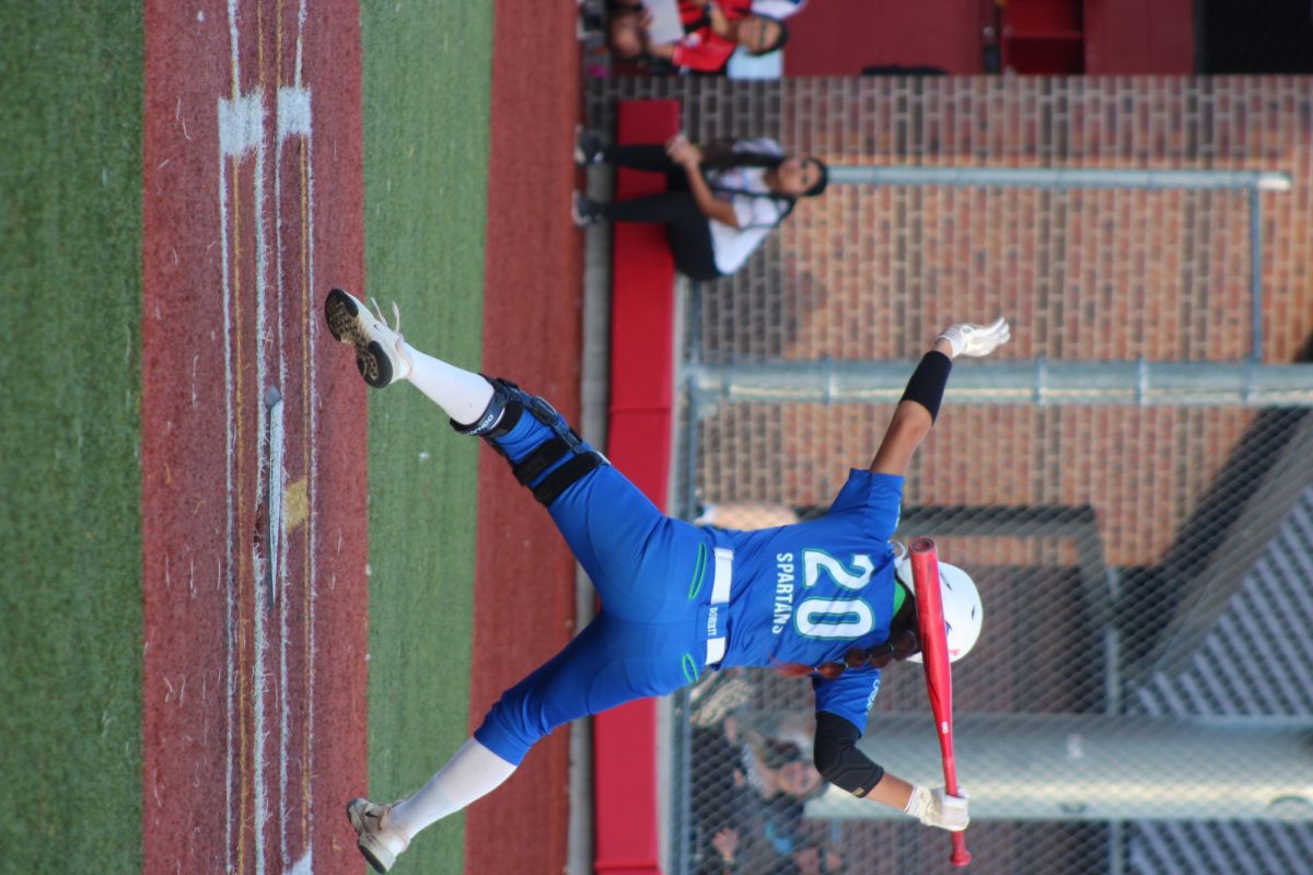 Anahlina Saiz jumping out of the way after the pitch almost hit her.