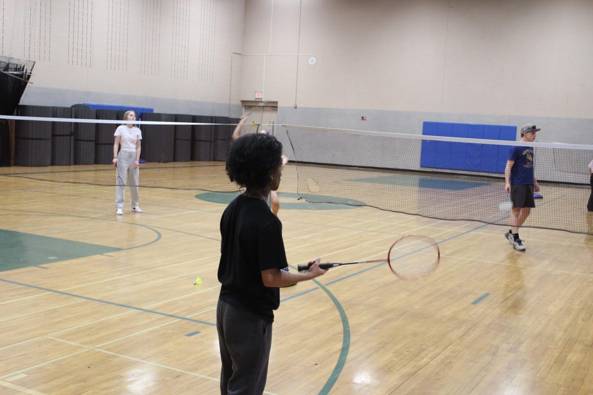 Xavier Gomez playing badminton in the small gym.