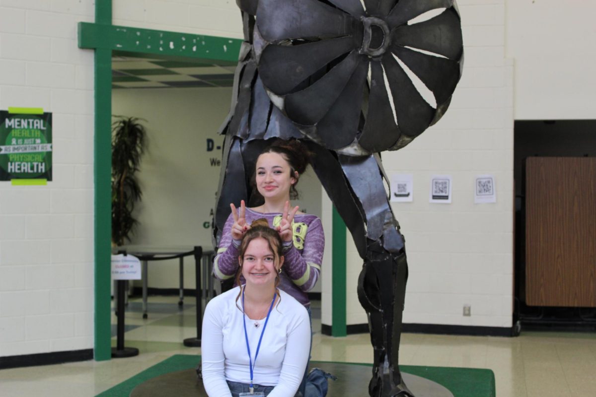 Avariella Miller and Grace Kirby posing in front if the Spartan statue. 