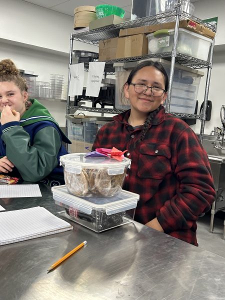 A Doherty student smiles with supplies for Harvest of Love