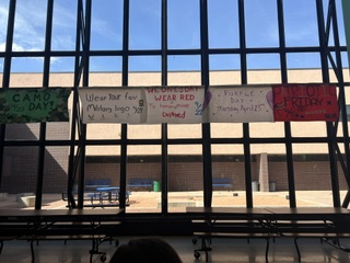In the cafeteria, Military Spirit Week information is displayed.