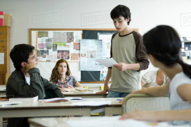 A group of students actively participate in a classroom.